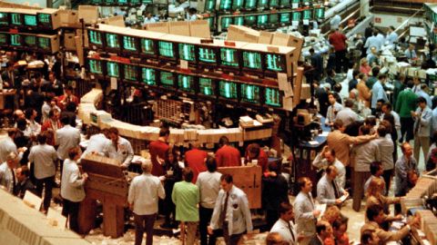 The floor of the American Stock Exchange in New York is crowded with workers as the Dow Jones Industrial Average plummeted about 157 points in one of its worst one-day losses, Oct. 27, 1987. (AP Photo/Osamu Honda)