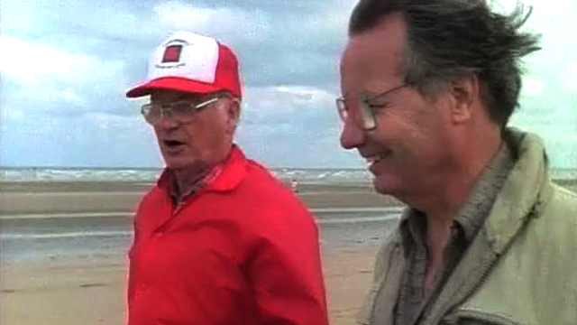 Bill and a veteran talk on the beaches of Normandy in 1989.