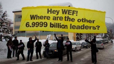 Protesters from the Occupy anti-capitalist movement release a banner reading ' Hey WEF! Where are the other 6.9999 billion leaders?' January 2012. (AP Photo/Anja Niedringhaus)