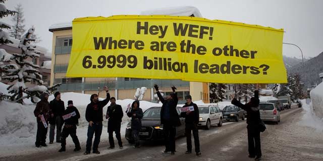 Protesters from the Occupy anti-capitalist movement release a banner reading ' Hey WEF! Where are the other 6.9999 billion leaders?' January 2012. (AP Photo/Anja Niedringhaus)