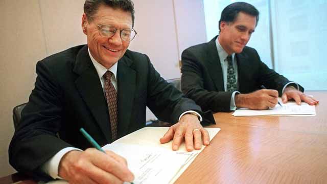 Mitt Romney and Thomas S. Monaghan sign an agreement for Bain Capital to buy a "significant portion" of Dominos Pizza. September 1998. (AP Photo/Domino's Pizza, Scott Gries, file)