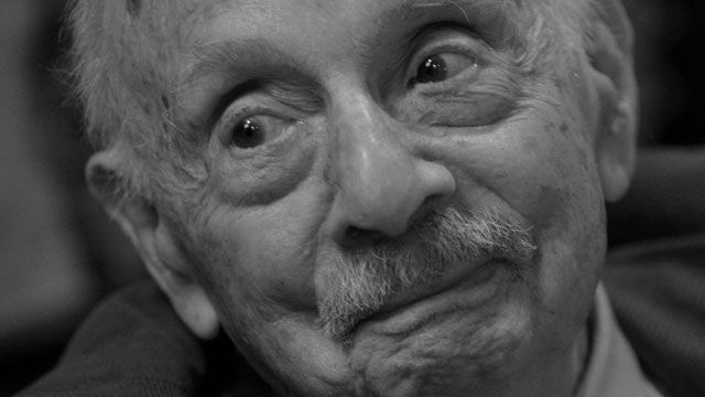 Poet Stanley Kunitz smiles as he talks with a visitor to a reception for his new book "The Wild Braid: A Poet Reflects on a Century in the Garden." May 2005. (AP Photo/Tina Fineberg, file)