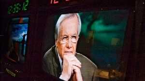 Bill Moyers on a TV studio monitor