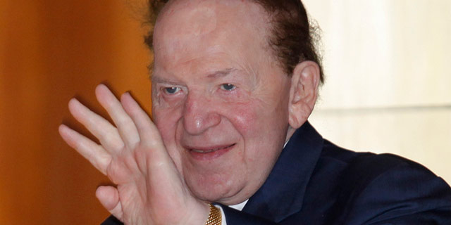 Las Vegas Sands Chairman and CEO Sheldon Adelson waving to reporters as he arrived for Sands China's annual meeting in Hong Kong. June 2011. (AP Photo/Vincent Yu, File)