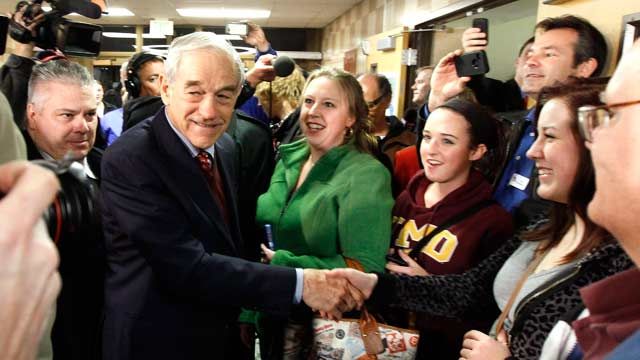 Republican presidential candidate Rep. Ron Paul shakes hands with caucus goers as he visits a caucus site in Coon Rapids, Minn. February 2012 (AP Photo/Charles Rex Arbogast)