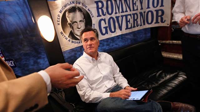 Republican presidential candidate Mitt Romney talks to aides on his campaign bus between campaign stops in Monroe, Mich., and Farmington Hills, Mich., February 2012 (AP Photo/Gerald Herbert)