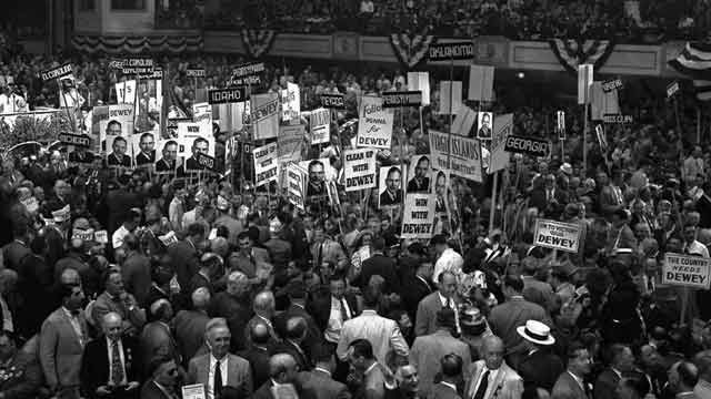 Delegates with posters and state signs crowd down the center aisle at Convention Hall in Philadelphia during a demonstration for Gov. Thomas E. Dewey. June 1948. (AP Photo)