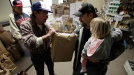 A man who had been laid off holds his daughter while taking free food from the weekly open food pantry at the Warren Family Mission in Warren, Ohio. March 2009 (AP /Amy Sancetta)