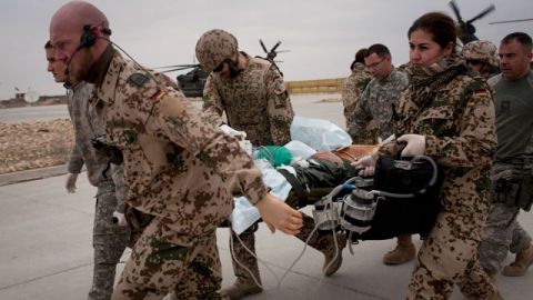 German and US Army soldiers rush with an injured German soldier to the German Army hospital in Kunduz, north of Kabul, Afghanistan. February 2011. (AP Photo/Anja Niedringhaus)