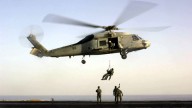 U.S. Navy Seals train with a SH-60F Seahawk helicopter on the flight deck of the USS Enterprise. October 2001. (AP Photo/U.S. Navy, Lance H. Mayhew Jr.)