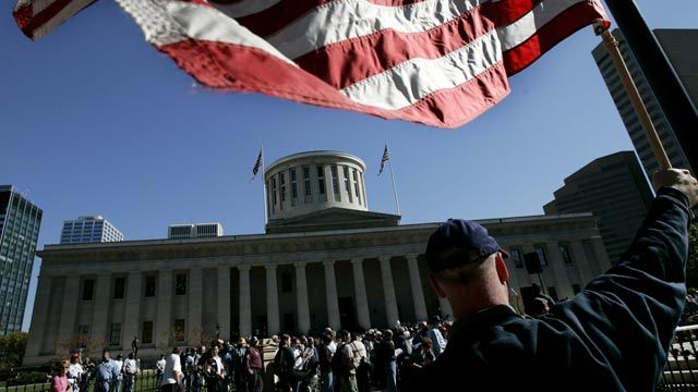 People gather at the state capitol building in Columbus, Ohio following a 2004 march sponsored by the Ohio Voter Protection Coalition. October 2004. (AP Photo/Laura Rauch)