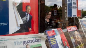 Newspapers and magazines carrying pictures of President-elect Francois Hollande are seen in a bookshop in Paris Monday. (AP Photo/Laurent Cipriani)