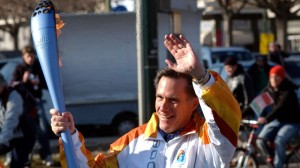 Mitt Romney carries the Olympic flame during the final leg of the torch relay for the Turin 2006 Winter Olympic Games in Torino, Italy. (AP Photo/Massimo Pinca, File)