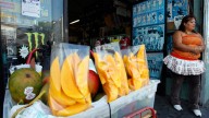 A street vendor sells fruit in Los Angeles. September 2010. (AP Photo/Damian Dovarganes)