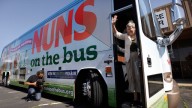 Sister Simone Campbell waves as she steps off the bus in Ames, Iowa, June 2012 (AP Photo/Charlie Neibergall)