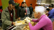 Volunteer Daphne Miller serves lunch at St. Anthony's dining hall, a soup kitchen for the city's homeless, in San Francisco. December 2005 (AP Photo/Marcio Jose Sanchez)