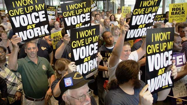 Supporters attending a labor rally hold signs supporting rights to unionize at United Steelworkers union headquarters in Pittsburgh, PA. July 2006. (AP Photo/Keith Srakocic)