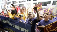 About 100 immigrant janitors marched through downtown Houston to protest a local cleaning company accused of withholding paychecks from its employees and not paying them for all hours they worked. June 2006 (AP Photo/David J. Phillip)