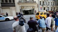 Photographers and videographers stand in a New York City Police Department-erected pen across the street from the garage entrance to Katie Holmes apartment building, after Holmes filed for divorce from husband Tom Cruise. July 2012 (AP Photo/Richard Drew)