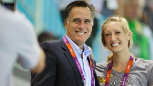 Swimmer Breeja Larson of the United States, right, poses for a photograph with U.S. Republican presidential candidate Mitt Romney during swimming heats at the Aquatics Centre in the Olympic Park during the 2012 Summer Olympics in London, Saturday, July 28, 2012. (AP Photo/Michael Sohn)