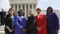 The five plaintiffs in a case of women employees against Wal-Mart: Stephanie Odle, of Norman, Okla., Betty Dukes, of Pittsburg, Calif., Deborah Gunter, of Palm Springs, Calif., Christine Kwapnoski, of Bay Point, Calif., and Edith Arena, of Duarte, Calif. pose for a photograph outside the Supreme Court in Washington. March 2011. (AP Photo/Jacquelyn Martin, File)