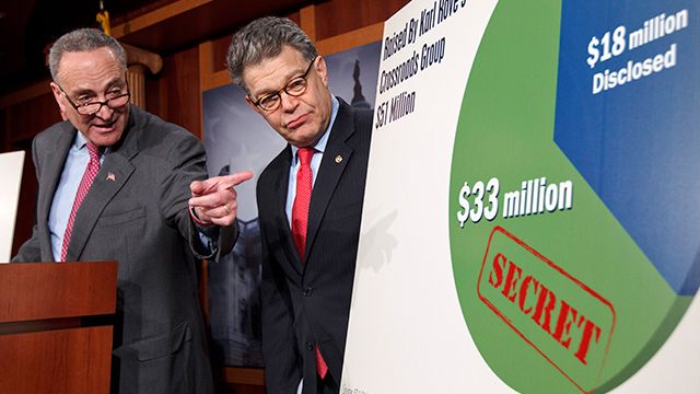 Sen. Charles Schumer, D-NY accompanied by Sen. Al Franken, D-Minn., speaks during a news conference to discuss the disclosure of super PAC donors to the Republican presidential candidates. February 2012. (AP Photo/J. Scott Applewhite)