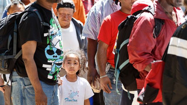 Homeless people line up in Franklin Park in downtown Washington to receive food and clothing from the congregation of Greater Saint John Church of Upper Marlboro, Md. May 2012. (AP Photo/J. Scott Applewhite)