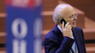 Karl Rove talks in his mobile phone as he walks across the floor before the second session of the Republican National Convention in Tampa, Fla. August 2012. (AP Photo/J. Scott Applewhite)