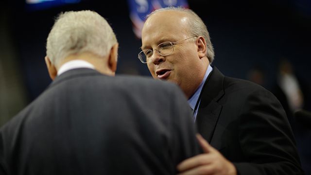 Karl Rove, former Senior Advisor and Deputy Chief of Staff to former President George W. Bush, right, talks to Sen. Orrin Hatch, R-Utah, on the floor of the Republican National Convention in Tampa, Fla. August 2012. (AP Photo/David Goldman)