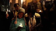 Courtney Thornton, 10, and her mother, Colleen Thornton, participate in a candlelight vigil outside the Chester-Upland School District administration building in Chester, Pa. School Administrators say they won't be able to make payroll Wednesday, Jan. 18, unless the state advances the district $18.7 million in expected funding. January 2012. (AP Photo/Matt Slocum)