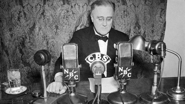 President Franklin D. Roosevelt shown at the White House, in Washington with an imposing battery of microphones lined up in front of him as he broadcast to the nation. January 1935. (AP Photo)