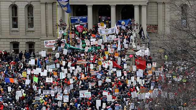 Protesters gather for a rally at the State Capitol in Lansing, Mich. protesting right-to-work legislation. December 2012. (AP Photo/Paul Sancya)