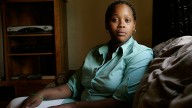 Toni Gates, a 24-year-old single mother, sits in the living room of her home in Milwaukee. May 2005. (AP Photo/Morry Gash)