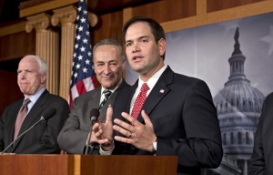 Sen. Marco Rubio, R-Fla., center, takes a reporter's question as a bipartisan group of leading senators announce that they have reached agreement on the principles of sweeping legislation to rewrite the nation's immigration laws, during a news conference at the Capitol in Washington, Monday, Jan. 28, 2013. From left are Sen. John McCain, R-Ariz., Sen. Charles Schumer, D-N.Y., and Sen. Marco Rubio, R-Fla. The deal covers border security, guest workers and employer verification, as well as a path to citizenship for the 11 million illegal immigrants already in this country. (AP Photo/J. Scott Applewhite)