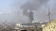Smoke rises from the building of Kabul traffic police headquarters during insurgents' attack, in Kabul, Afghanistan, Monday, Jan. 21, 2013. Taliban insurgents wearing suicide vests attacked the headquarters before dawn Monday, police said, and eyewitnesses heard numerous explosions while a gun battle was still raging nearly four hours later. (AP Photo/Musadeq Sadeq)