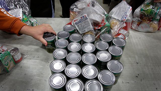 Volunteers fill bags with food for part of their backpack school lunch program at the Cleveland Foodbank in Cleveland on Tuesday, Nov. 22, 2011. The Foodbank provides take home lunches for school children on the days they do not have classes, and with the four-day holiday from school surrounding Thanksgiving, many more of the meals are needed. (AP Photo/Amy Sancetta)