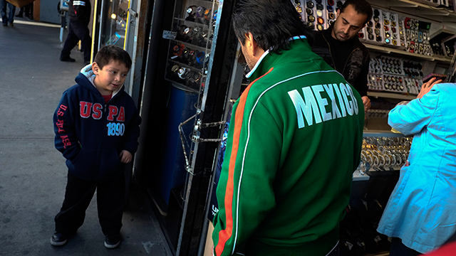 Mexican immigrant Roberto Garcia, center, and son Alan, left, look at wrist watches while shopping in Los Angeles, Monday, Jan. 28, 2013. Seeking swift action on immigration, President Barack Obama on Tuesday will try to rally public support behind his proposals for giving millions of illegal immigrants a pathway to citizenship, as well as making improvements to the legal immigration system and border security. (AP Photo/Jae C. Hong)