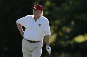 Donald Trump stands on the 14th fairway during a pro-am round of the AT&T National golf tournament at Congressional Country Club, Wednesday, June 27, 2012, in Bethesda, Md. Trump is worried that wind turbines will spoil the view from his new golf course in Aberdeen, Scotland. (AP Photo/Patrick Semansky)
