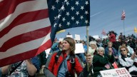 Patrick Will of Eaton, N.Y., holds an American flag during a tax day tea party rally in Albany, N.Y. (AP Photo/Mike Groll)