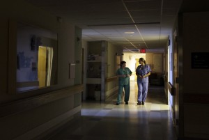 Nurses walk under dimmed lighting during 'quiet time' at the Newborn Family Unit at the Massachusetts General Hospital in Boston.  (AP Photo/Elise Amendola)