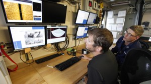 In a Tuesday, June 5, 2012 photo, Lt. Sam Greenaway, right, looks at side scan sonar data along with survey tech Dvid Moehl, left, aboard the National Oceanographic and Atmospheric Administration research ship Ferdinand R. Hassler in Norfolk, Va. The federal research vessel that will help update nautical charts on the East Coast will be commissioned Friday June 8, 2012. (AP Photo/Steve Helber)