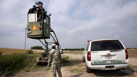 In this April 19, 2011, file photo, a member of the National Guard checks on his colleague inside a Border Patrol Skybox near the Hidalgo International Bridge in Hidalgo, Texas. National Guard members along the Texas-Mexico border assist Border Patrol by surveying the terrain from the tower.