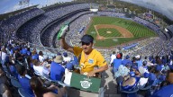 Henry Rivera sells peanuts during the Los Angeles Dodgers' Opening Day baseball game against the San Francisco Giants at Dodger Stadium, Monday, April 1, 2013, in Los Angeles. (AP Photo/Mark J. Terrill)
