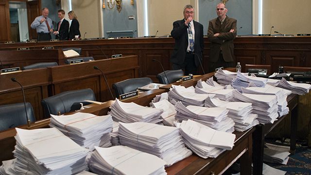 FILE - This May 15, 2013 file photo shows stacks of paperwork awaiting members of the House Agriculture Committee, on Capitol Hill in Washington, as it met to consider proposals to the 2013 Farm Bill. The Senate has rejected an amendment By Sen. James Inhofe, R-Okla. to turn the federal food stamp program over to the states. (AP Photo/J. Scott Applewhite, File)