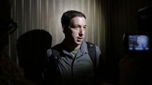 Glenn Greenwald, a reporter of The Guardian, speaks to reporters at his hotel in Hong Kong Monday, June 10, 2013. (AP Photo/Vincent Yu)