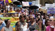 Marjorie Hill, second left, CEO of the Gay Men's Health Crisis, address the Women for Paid Sick Days rally on the steps of New York's City Hall last summer. (AP Photo/Richard Drew)