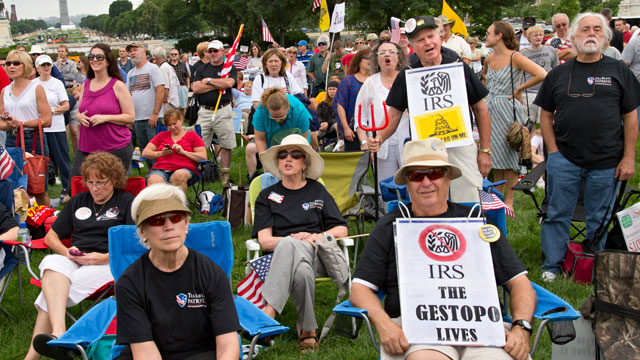 Tea party activists attend a rally on the grounds of the U.S. Capitol in Washington, Wednesday, June 19, 2013. The IRS has been under fire from Democrats and Republicans in Congress since May, when one of its officials publicly apologized for targeting conservative groups' applications for tax-exempt status for close examination. (AP Photo/J. Scott Applewhite)