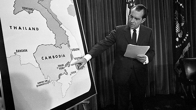 US President Richard Nixon poses in the White House after his announcement to the nation April 30, 1970 that American ground troops have attacked, at his order, a Communist complex in Cambodia. Nixon points to area of Vietnam and Cambodia in which the action is taking place. (AP Photo)