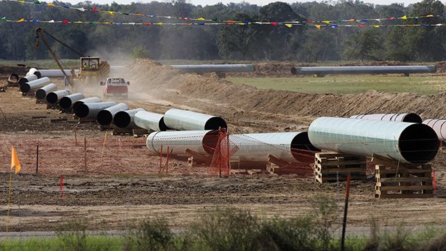 Large sections of pipe are shown on a neighboring property to Julia Trigg Crawford family farm Thursday, Oct. 4, 2012, in Sumner Texas. Oil has long lived in harmony with farmland and cattle across the Texas landscape, a symbiosis nurtured by generations and built on an unspoken honor code that allowed agriculture to thrive while oil was extracted. (AP Photo/Tony Gutierrez)