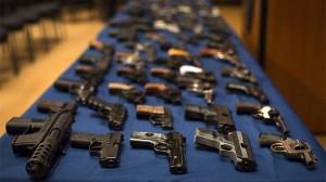 Nearly 100 confiscated illegal firearms rests on a table before a press conference with Mayor Michael Bloomberg, NYPD Police Commissioner Ray Kelly, and New York City District Attorney Cyrus Vance, Friday, Oct. 12, 2012 in New York. (AP Photo/John Minchillo)